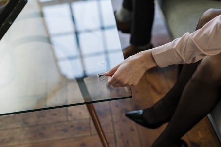 woman putting wedding ring on table